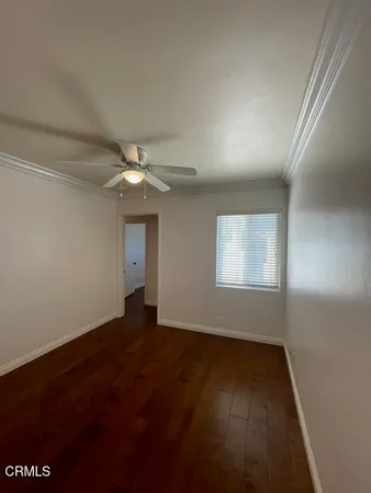 an empty room with a ceiling fan and a window