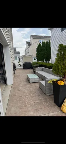 a view of swimming pool with outdoor seating and in back