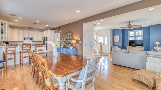 a dining room with furniture and wooden floor