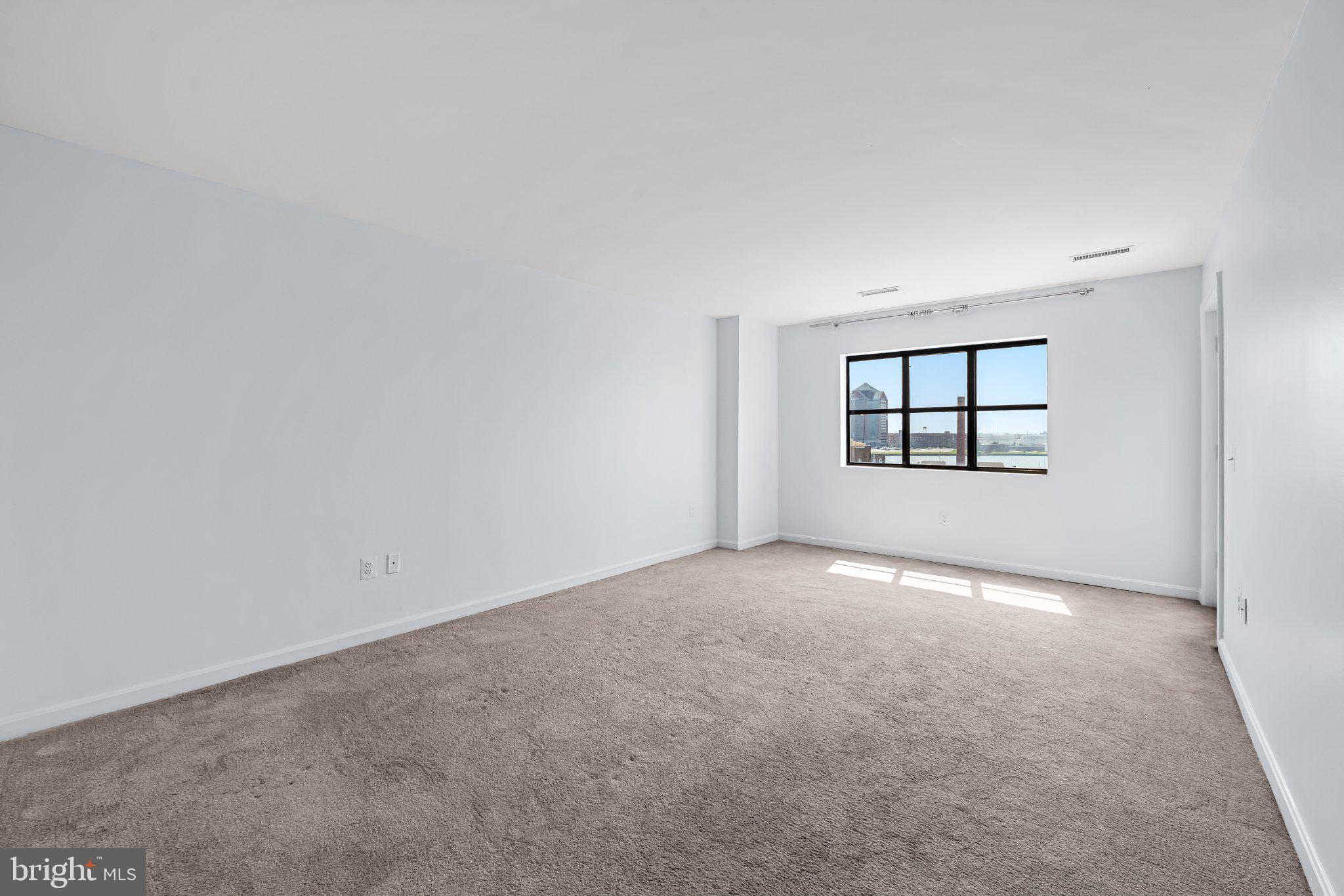 2702 Lighthouse Point East, Unit 738 Baltimore, MD 21224 - Photo 28 of 33 Spacious room with natural light.