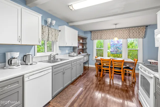 a kitchen with stainless steel appliances granite countertop sink stove top oven and cabinets