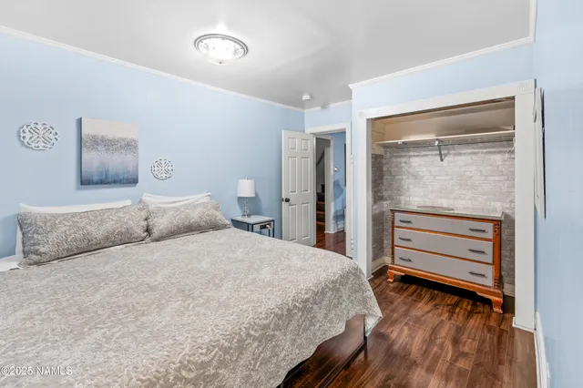 a bedroom with a bed and a dresser