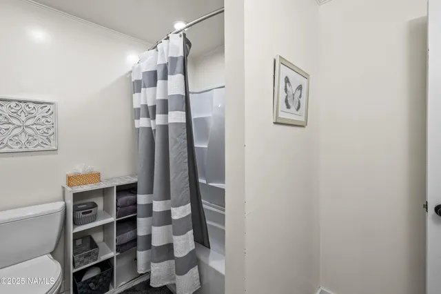 a view of a bedroom with wooden floor and closet