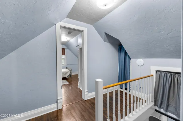 a view of a hallway view with wooden floor and staircase