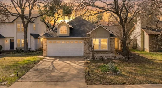 a view of a house with a yard covered with snow in front of it