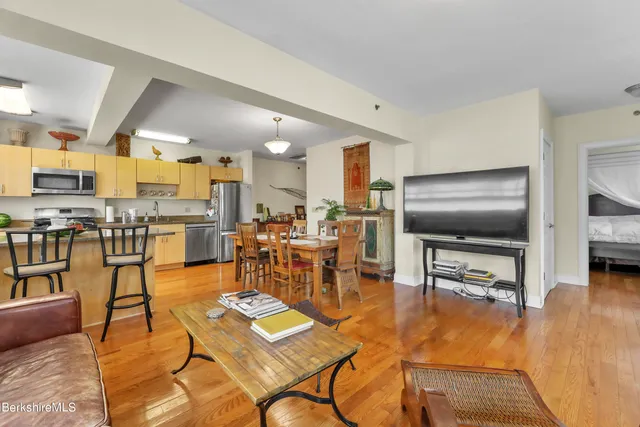 a living room with lots of furniture and kitchen view