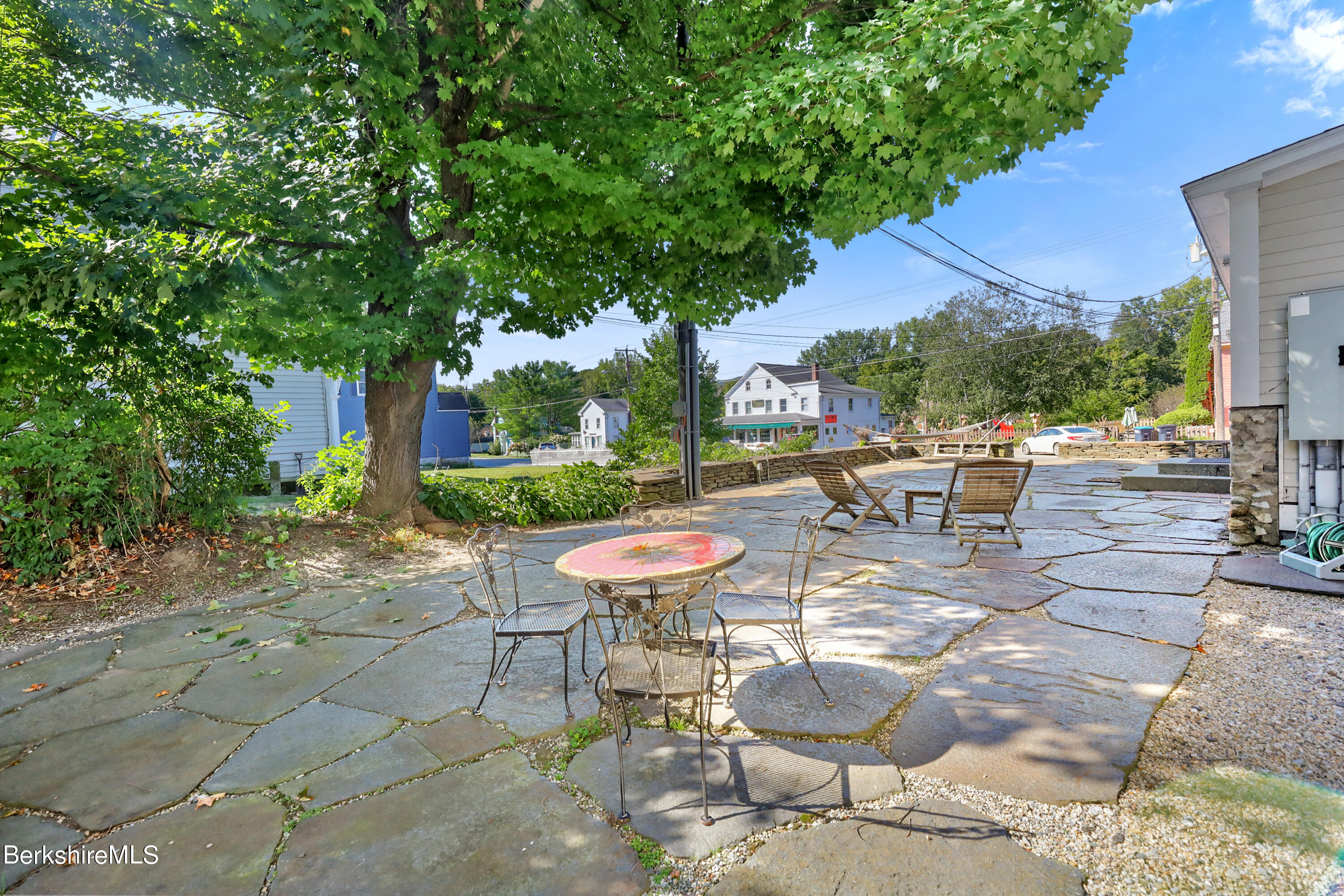29 Main Street West Stockbridge, MA 01266 - Photo 5 of 51 a view of a patio with a dining table and chairs under an umbrella