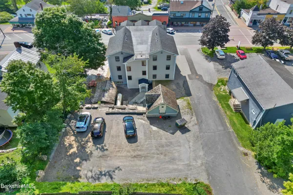 an aerial view of multiple houses with yard