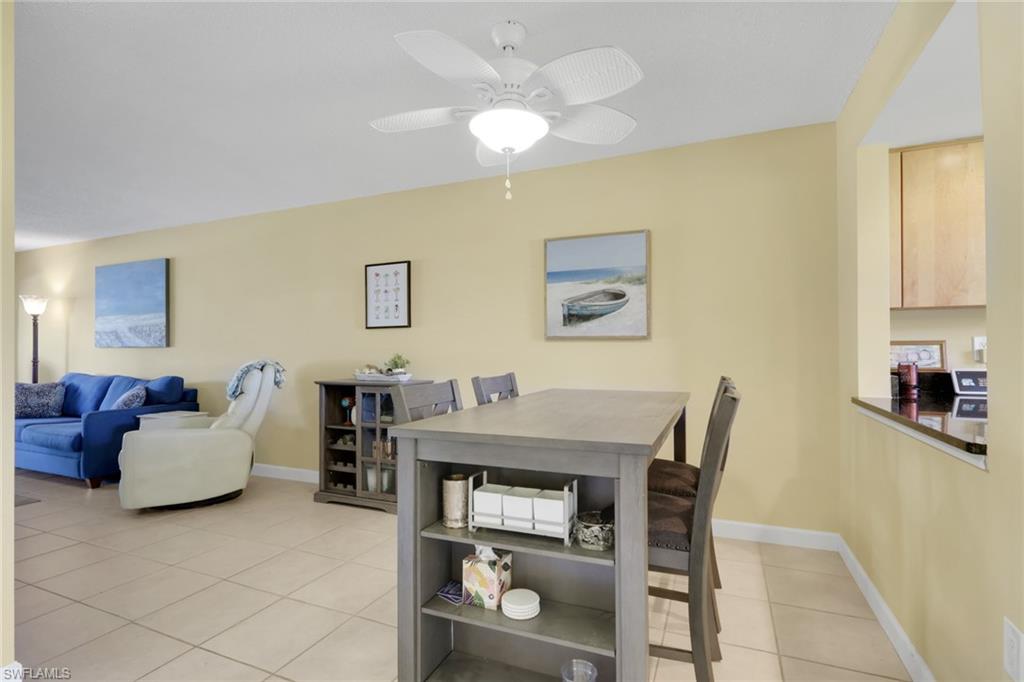 315 St Andrews Boulevard, Unit C5 Naples, FL 34113 - Photo 8 of 40 a view of a dining room with furniture and wooden floor
