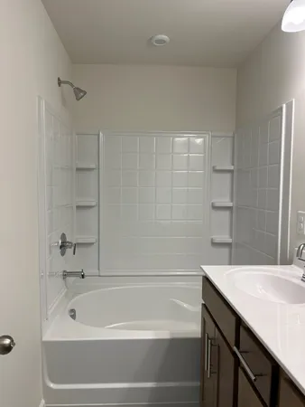 a bathroom with a bathtub and a sink