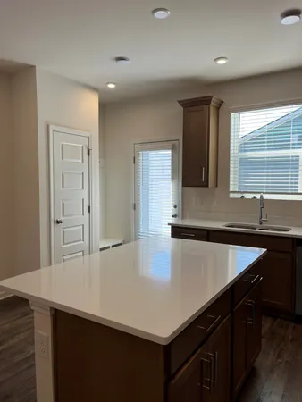a kitchen with a sink cabinets and window