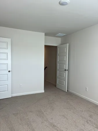 a view of an empty room and fire place