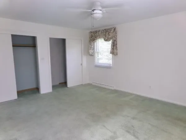 a bathroom with a sink a toilet a mirror and shower