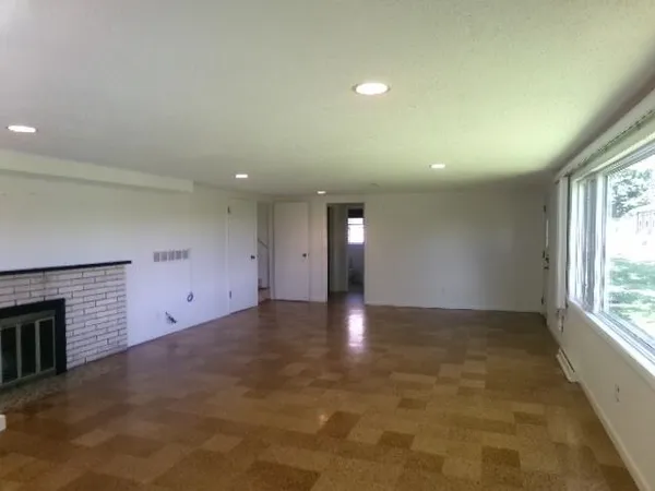 a kitchen with a sink a stove a refrigerator and white cabinets