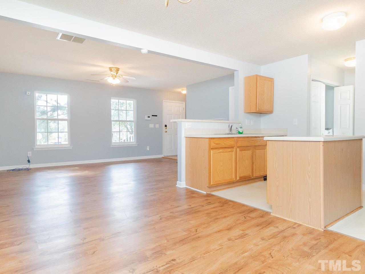 5801 Weddington Road Raleigh, NC 27610 - Photo 11 of 28 a view of a kitchen with wooden floor and windows