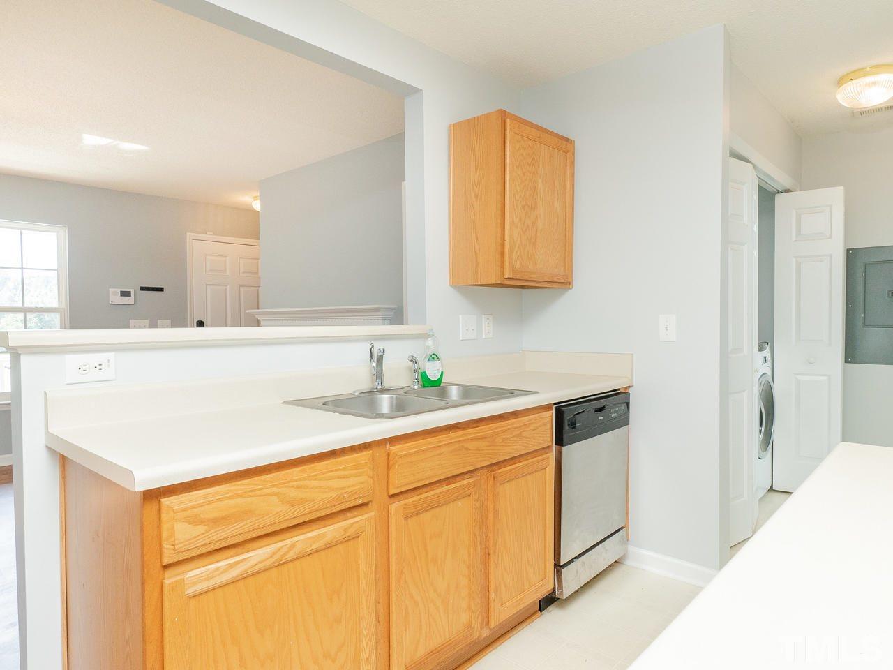 5801 Weddington Road Raleigh, NC 27610 - Photo 12 of 28 a kitchen with stainless steel appliances granite countertop a sink and a white cabinets