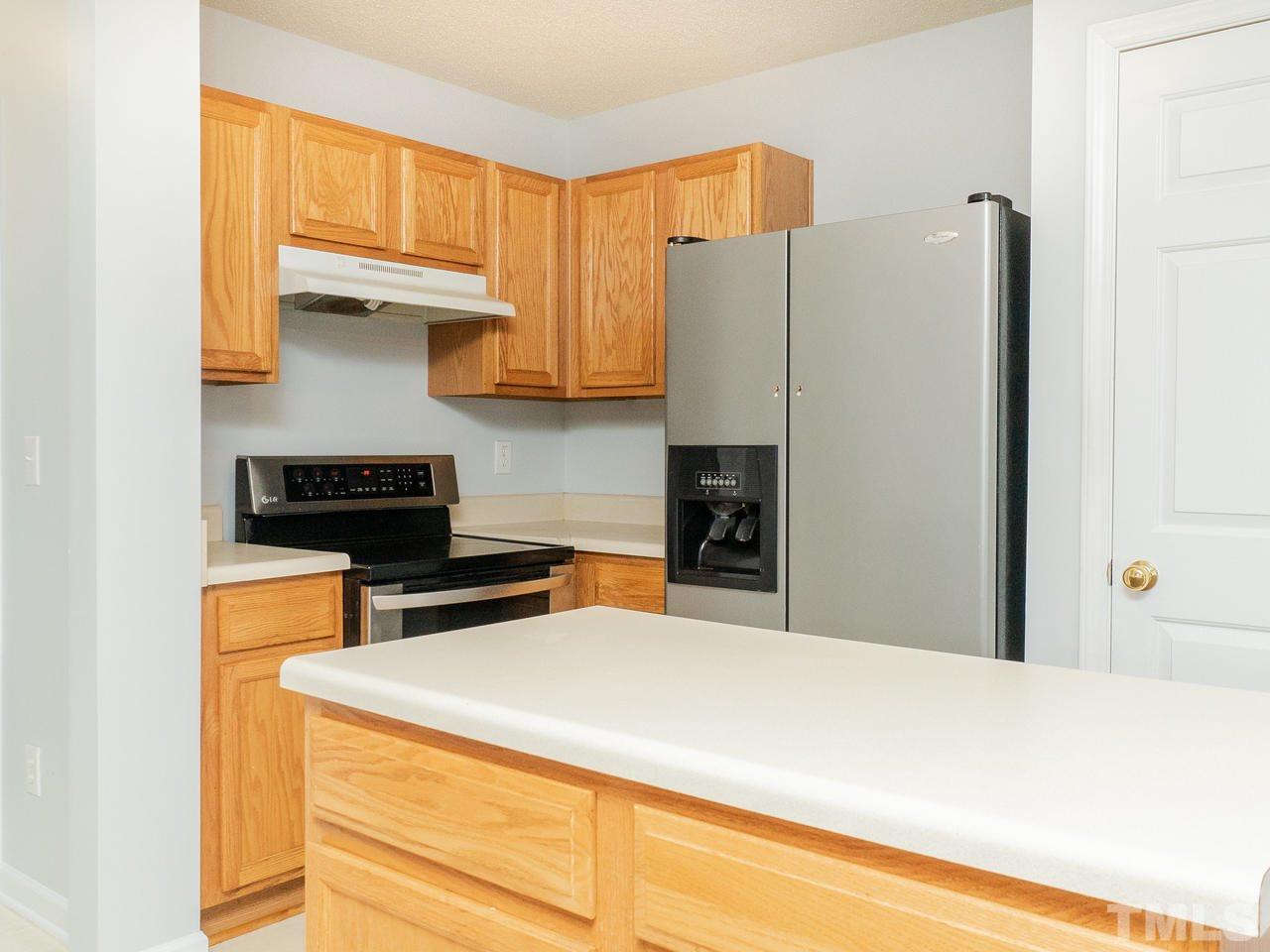 5801 Weddington Road Raleigh, NC 27610 - Photo 13 of 28 a kitchen with a refrigerator a stove and a refrigerator