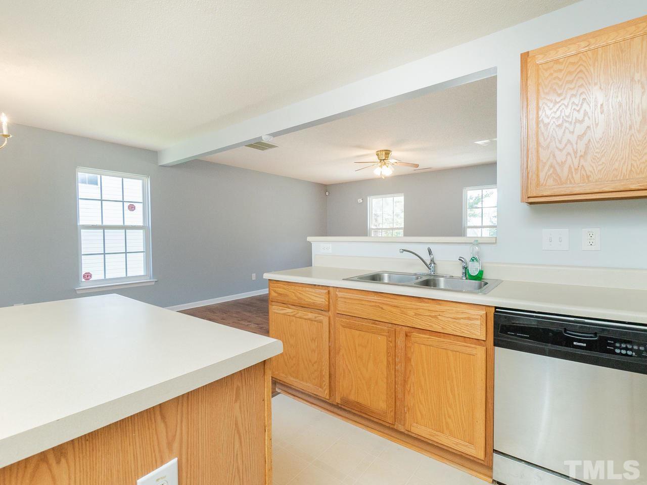 5801 Weddington Road Raleigh, NC 27610 - Photo 14 of 28 a kitchen with stainless steel appliances cabinets and wooden floor