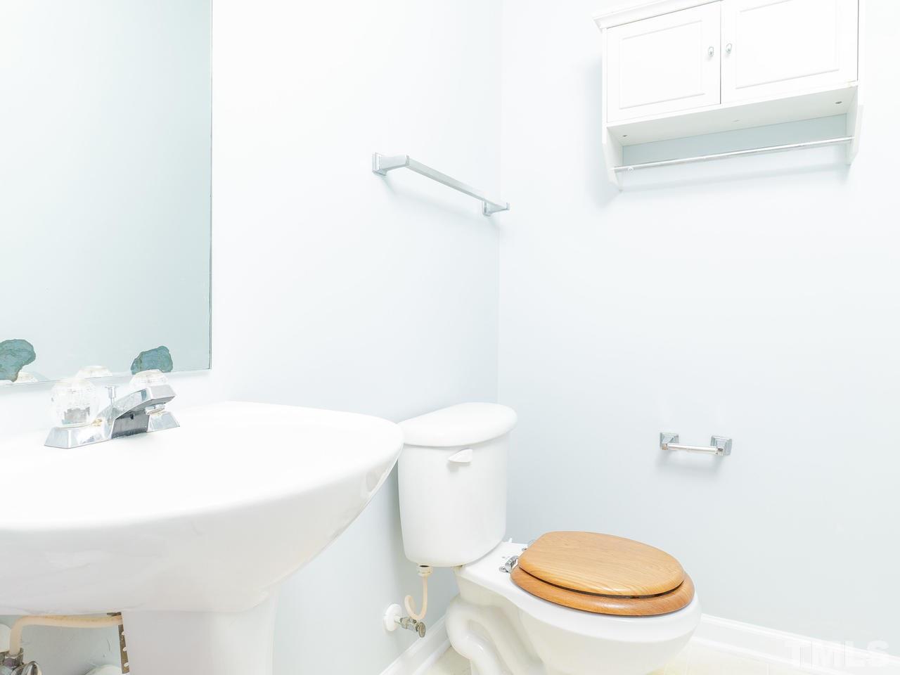 5801 Weddington Road Raleigh, NC 27610 - Photo 16 of 28 a bathroom with a sink a toilet and a mirror