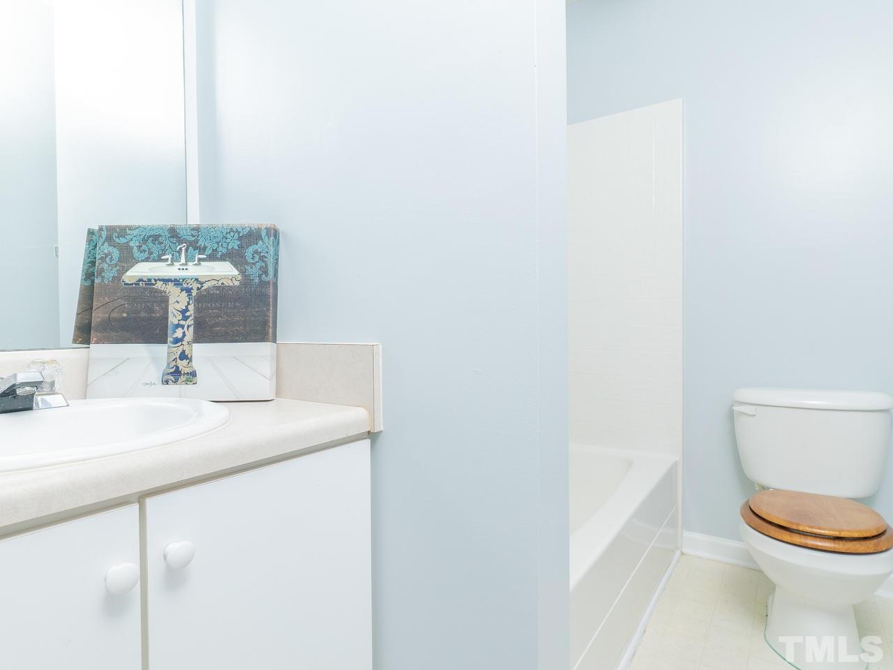 5801 Weddington Road Raleigh, NC 27610 - Photo 19 of 28 a bathroom with a toilet a sink and mirror