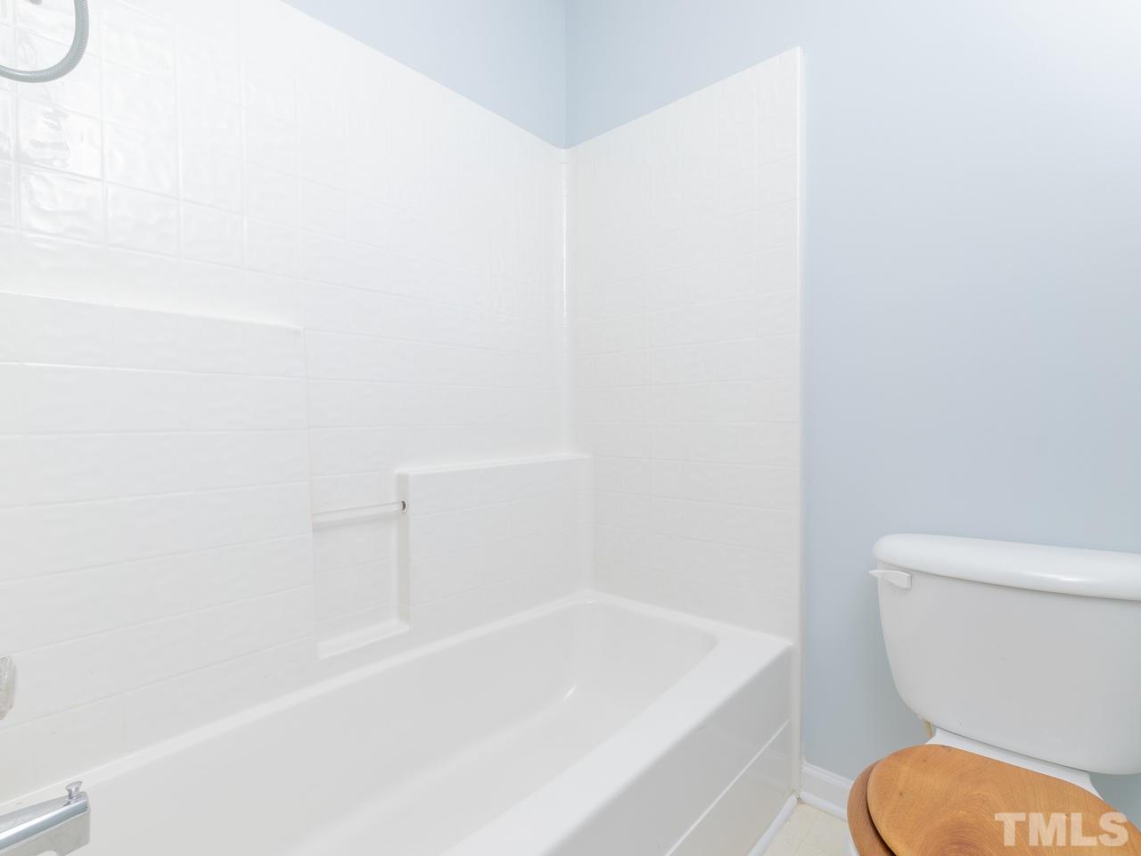 5801 Weddington Road Raleigh, NC 27610 - Photo 20 of 28 a bathroom with a toilet and a bathtub