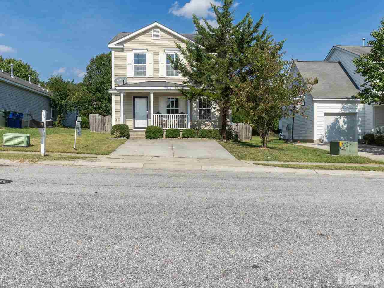 5801 Weddington Road Raleigh, NC 27610 - Photo 3 of 28 a view of yellow house with a big yard and large trees