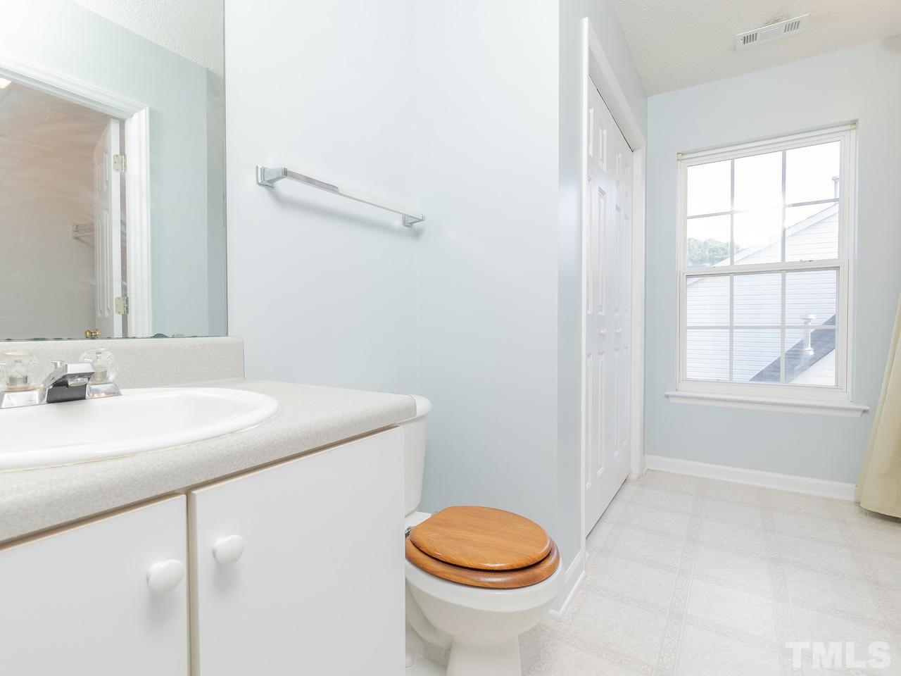 5801 Weddington Road Raleigh, NC 27610 - Photo 23 of 28 a bathroom with a sink toilet and window