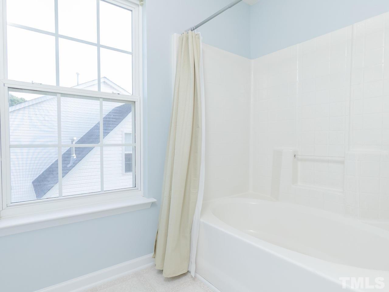 5801 Weddington Road Raleigh, NC 27610 - Photo 24 of 28 a bathroom with a bathtub and a shower