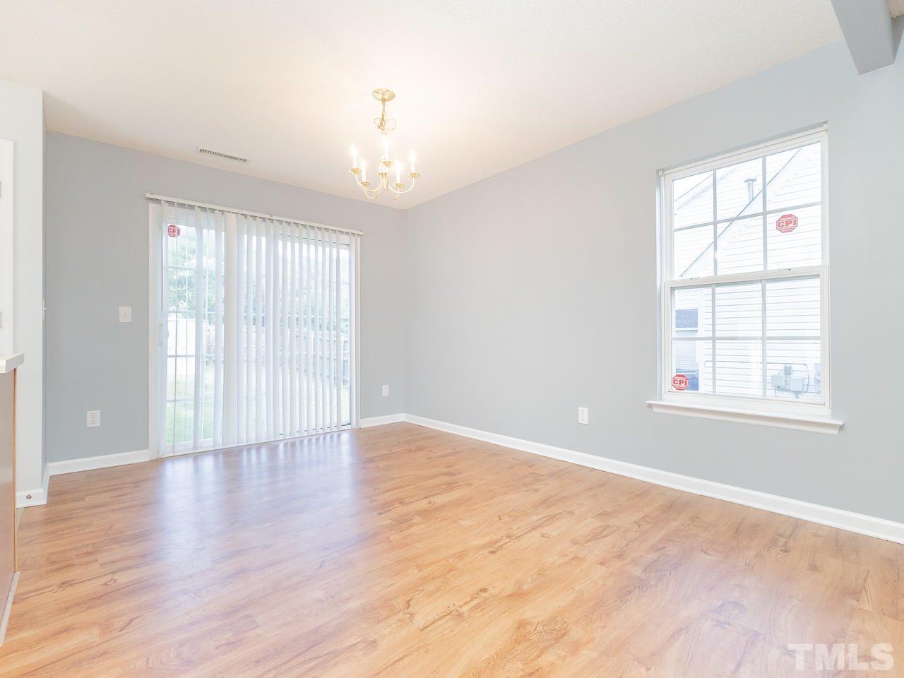 5801 Weddington Road Raleigh, NC 27610 - Photo 9 of 28 an empty room with wooden floor and windows