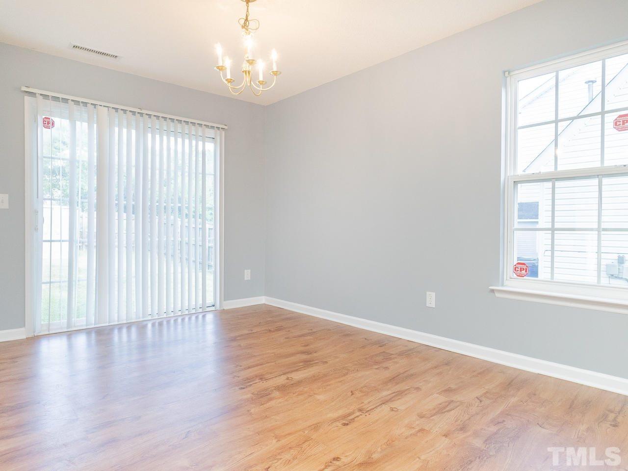 5801 Weddington Road Raleigh, NC 27610 - Photo 10 of 28 an empty room with wooden floor and windows
