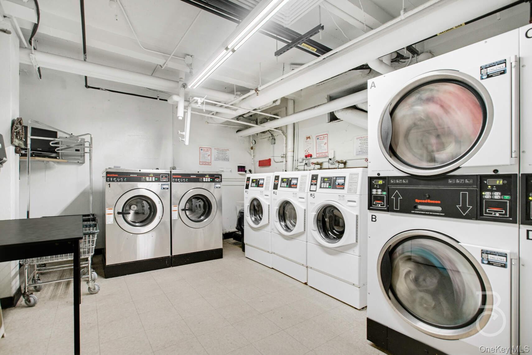 34-20 79th Street, Unit 6I Queens, NY 11372 - Photo 13 of 15 a utility room with dryer washer and a view of kitchen