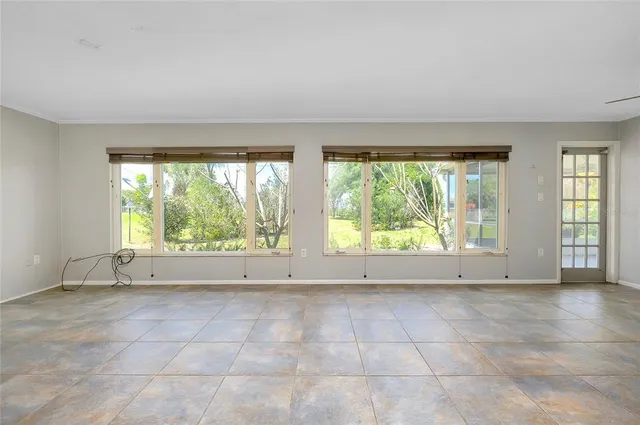 an empty room with windows and closet