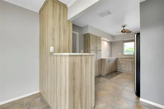 a kitchen with granite countertop a stove and a refrigerator with cabinets