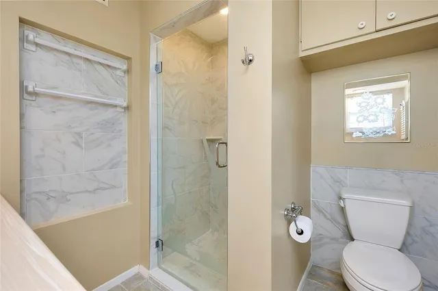 a view of a house with backyard sitting area and garden