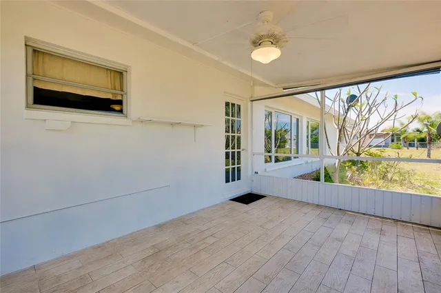 a view of a house with backyard and a tree