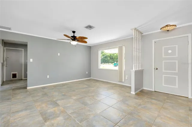 a view of a livingroom with a ceiling fan and window