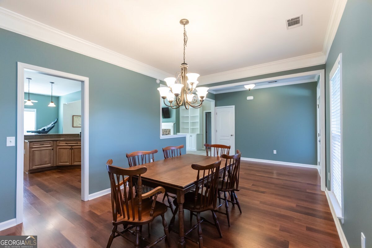 135 Runs Crossing Drive Springfield, GA 31329 - Photo 11 of 38 a view of a dining room with furniture window and wooden floor