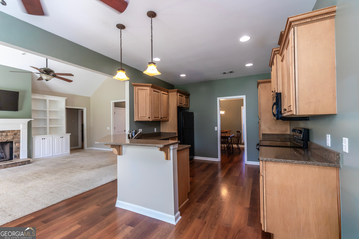 135 Runs Crossing Drive Springfield, GA 31329 - Photo 16 of 38 a kitchen with stainless steel appliances granite countertop a sink a stove and a wooden floors