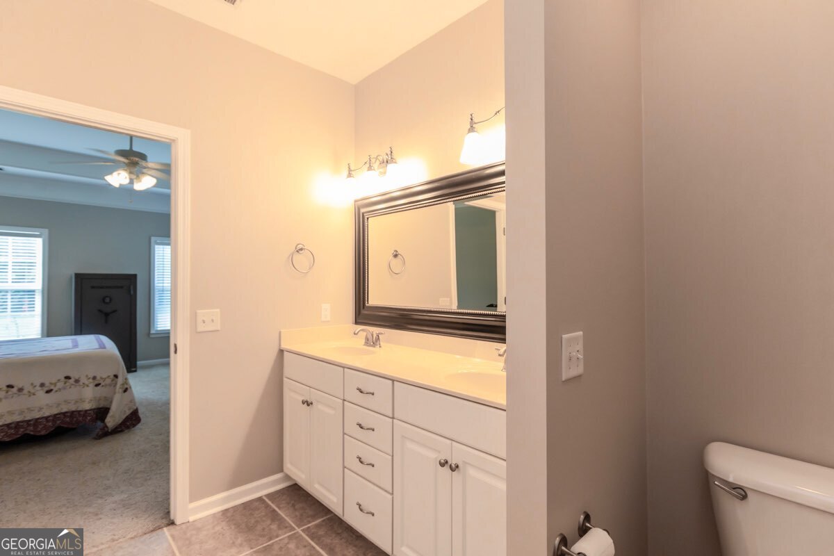 135 Runs Crossing Drive Springfield, GA 31329 - Photo 23 of 38 a en suite bathroom with a sink a mirror and a toilet