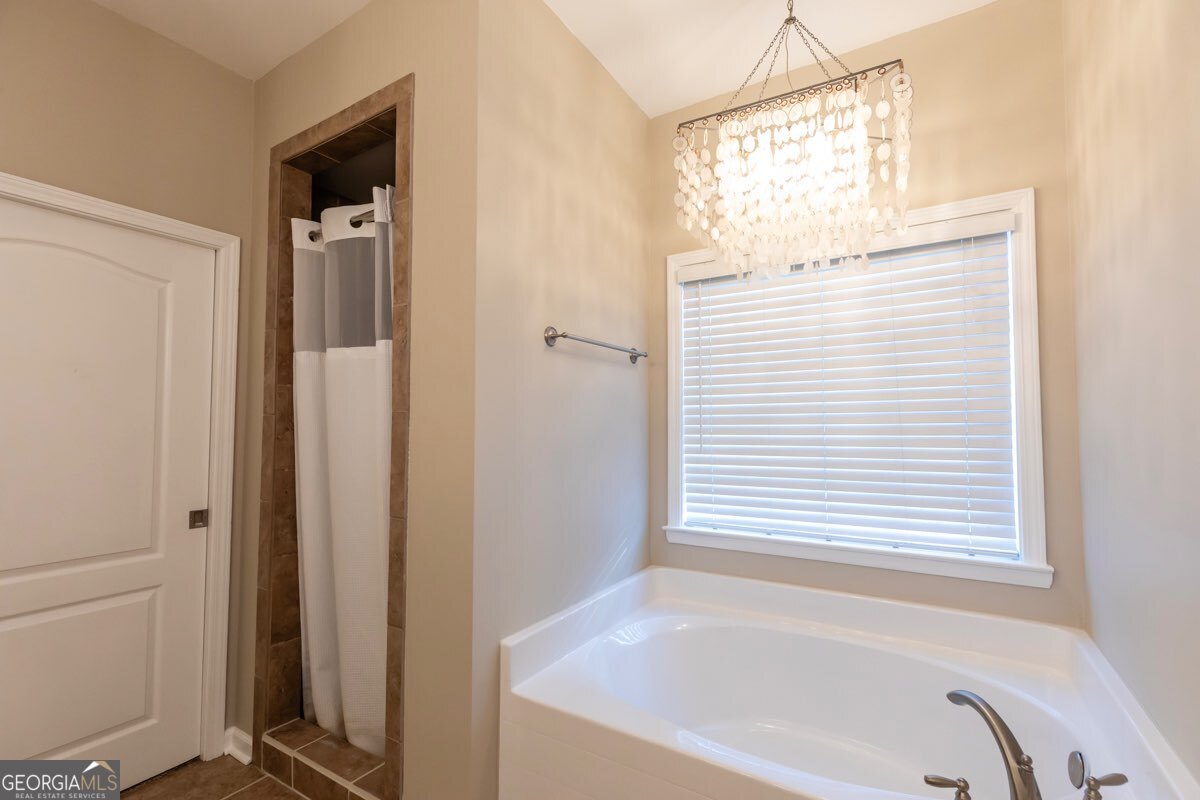 135 Runs Crossing Drive Springfield, GA 31329 - Photo 24 of 38 a bathroom with a bathtub and a window