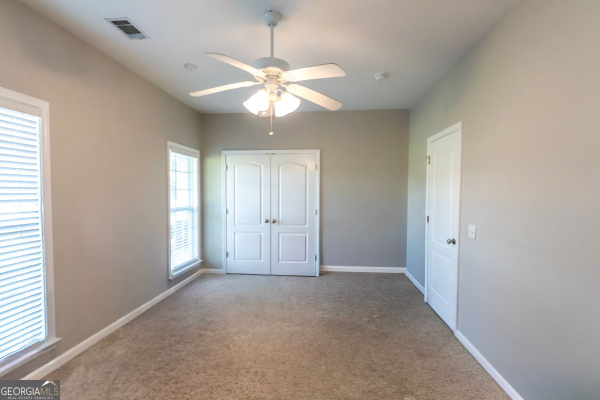 135 Runs Crossing Drive Springfield, GA 31329 - Photo 31 of 38 wooden floor in an empty room with a window