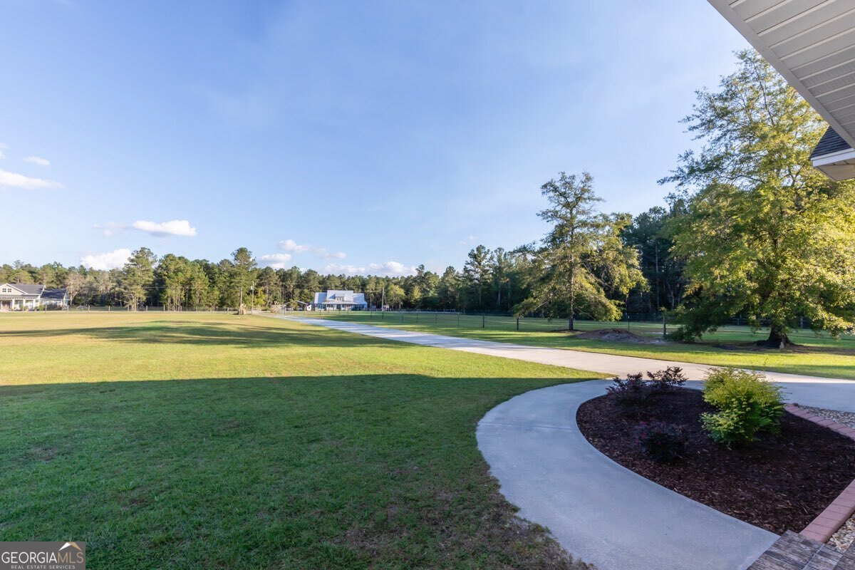 135 Runs Crossing Drive Springfield, GA 31329 - Photo 5 of 38 a view of a swimming pool and lake