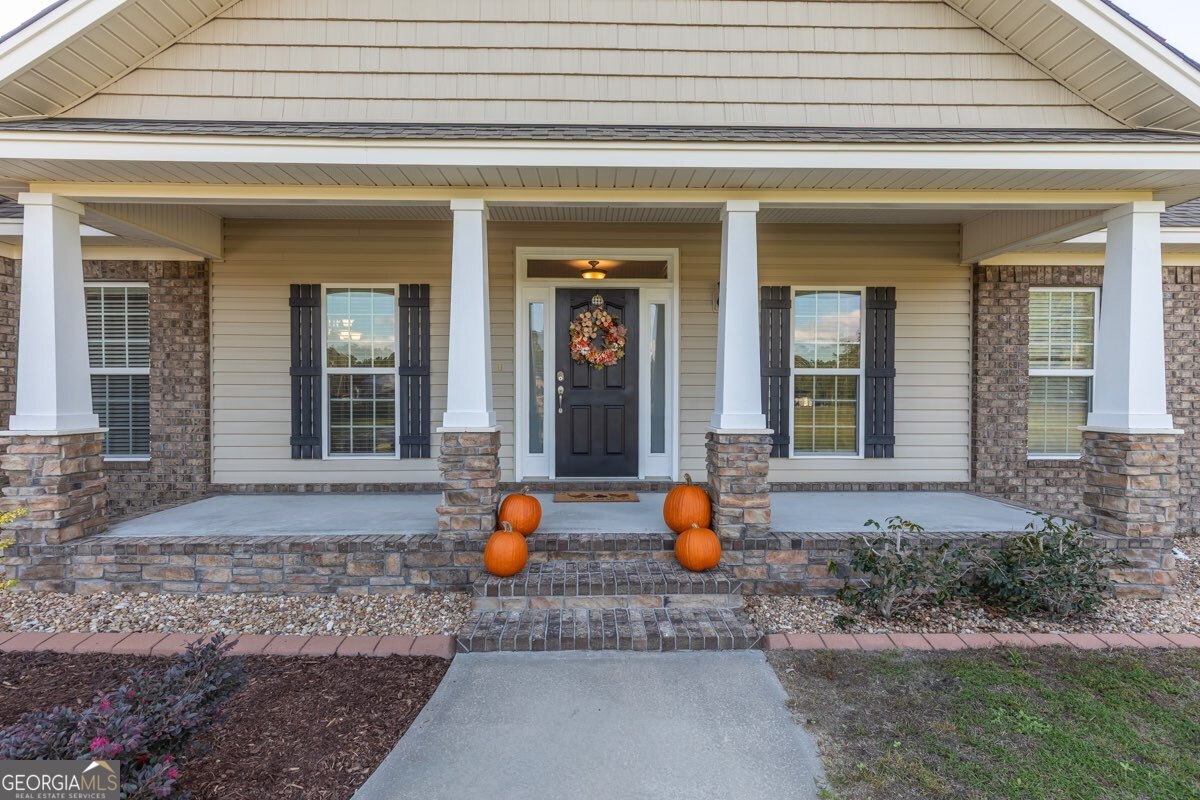 135 Runs Crossing Drive Springfield, GA 31329 - Photo 6 of 38 a view of a entrance door of the house