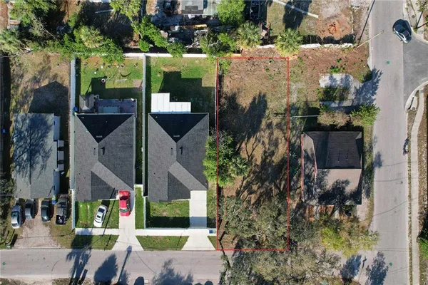 an aerial view of a houses with yard