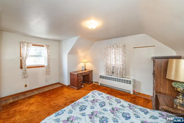 a bedroom with a bed and a television in it