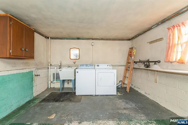 a utility room with cabinets washer and dryer
