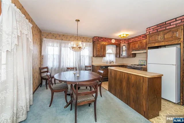 a kitchen with a table chairs and a wooden floor