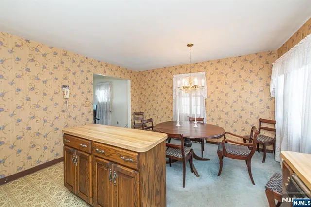 a view of a dining room with furniture and window