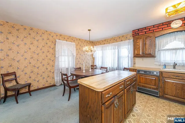 a kitchen with a sink a stove and a refrigerator