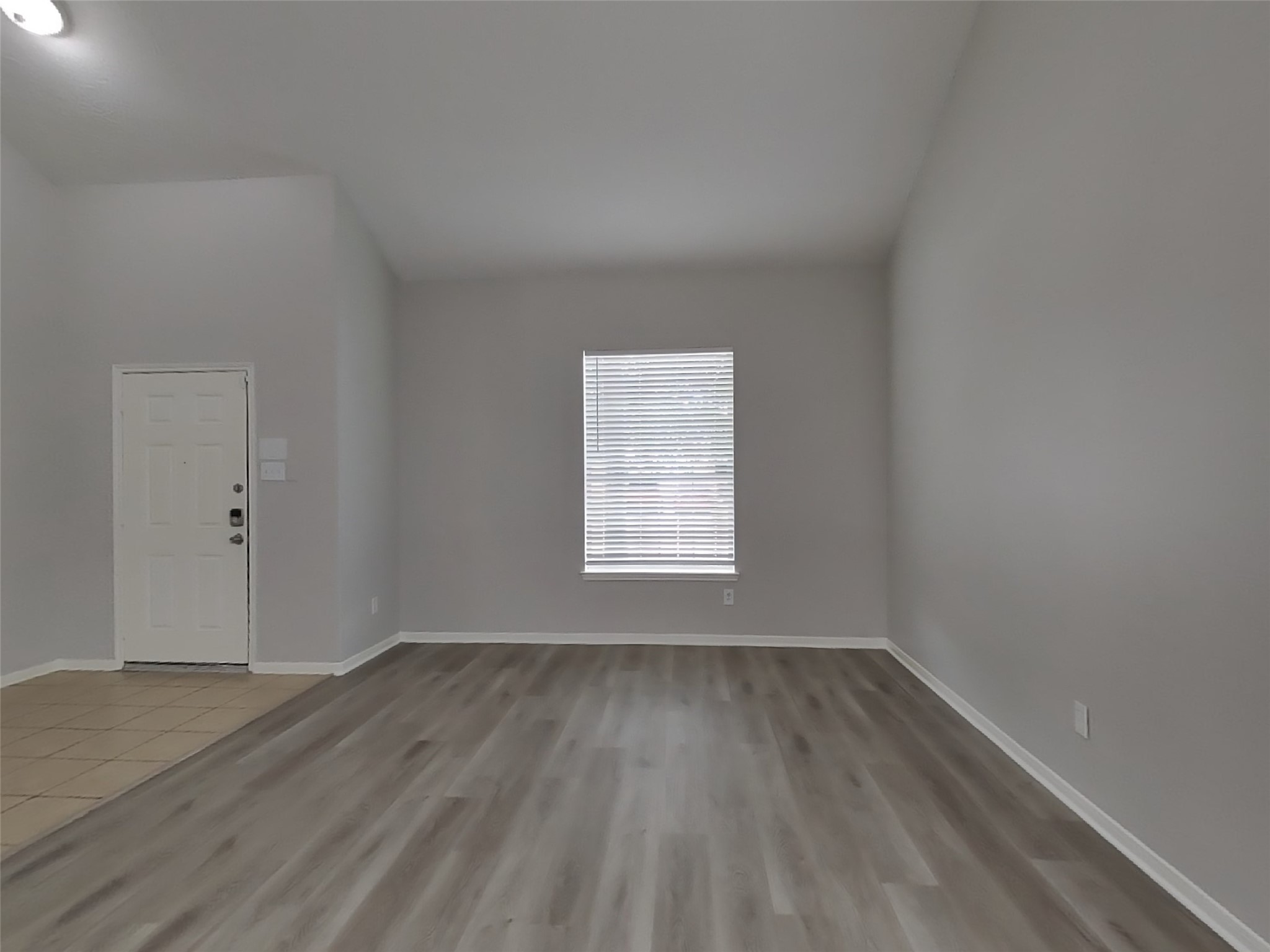 21526 Lovis Way Humble, TX 77338 - Photo 16 of 17 an empty room with wooden floor and windows